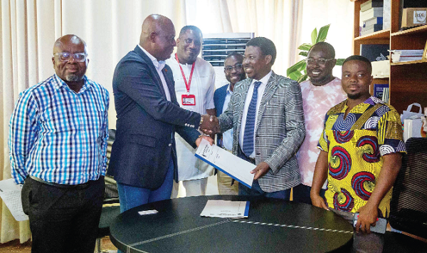 Ato Afful (2nd from left), Managing Director, GCGL, exchanging the signed documents with Prof. Justice Nyigmah Bawole (3rd from right), Dean, University of Ghana Business School. Also in the photograph are Franklin Sowa (3rd from left), Director, Marketing and Sales, GCGL; Charles Benoni Okine (4th from right), acting Editor, Graphic Business, Dr Raphael Odoom (right), Senior Lecturer, Department of Marketing and Entrepreneurship, UGBS, and Emmanuel Poku-Sarkodie (left), Deputy Registrar, UGBS